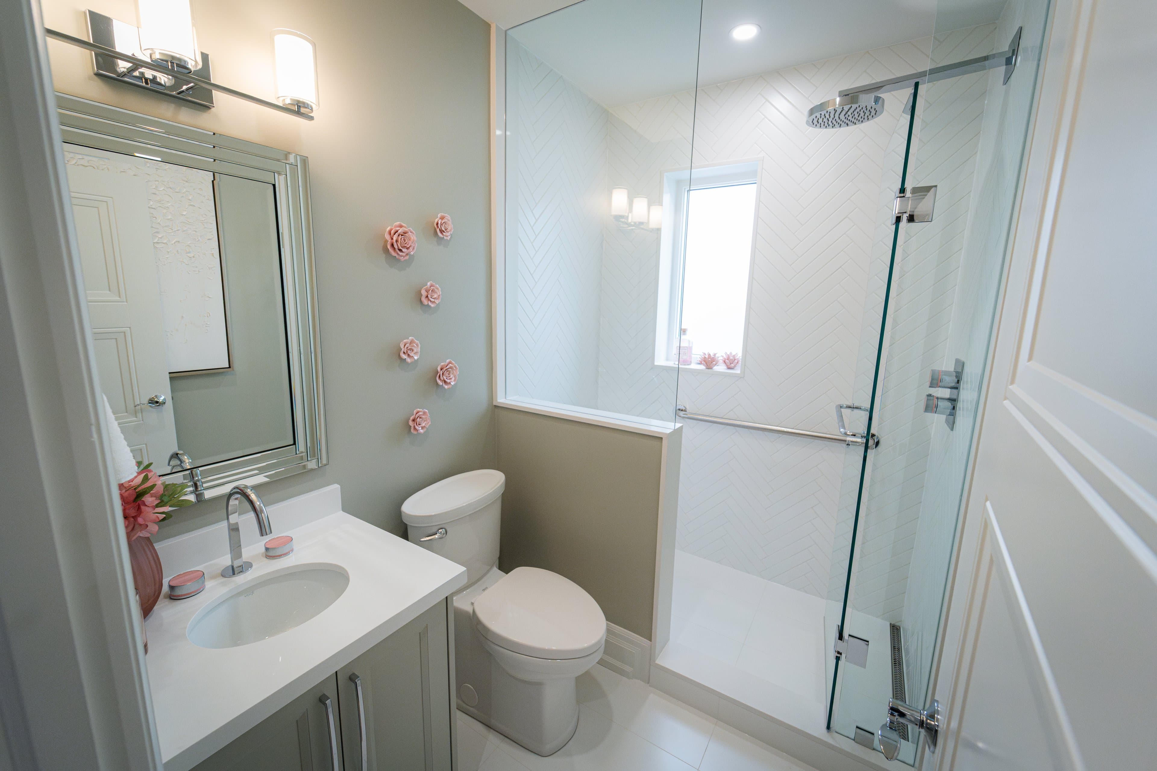 Modern bathroom with herringbone tile shower and floral accents