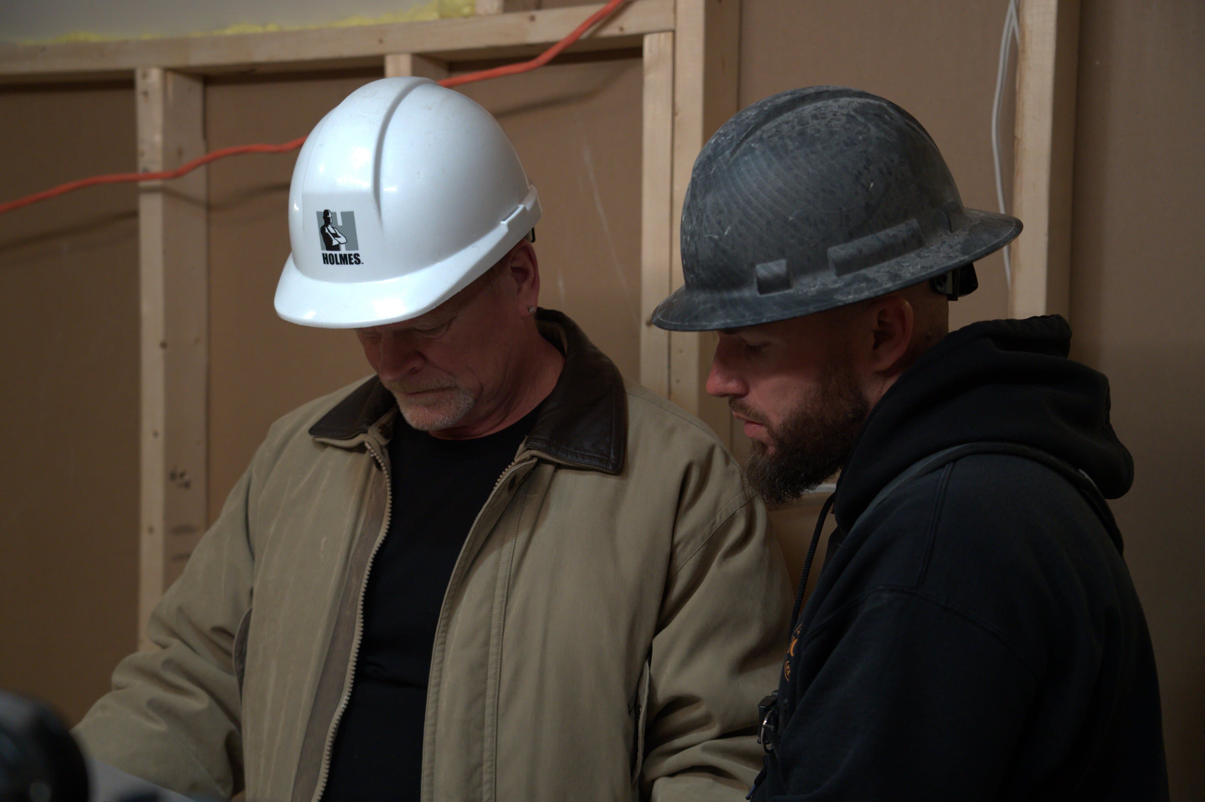 Blake Steed discussing project plans with Mike Holmes during a renovation planning session